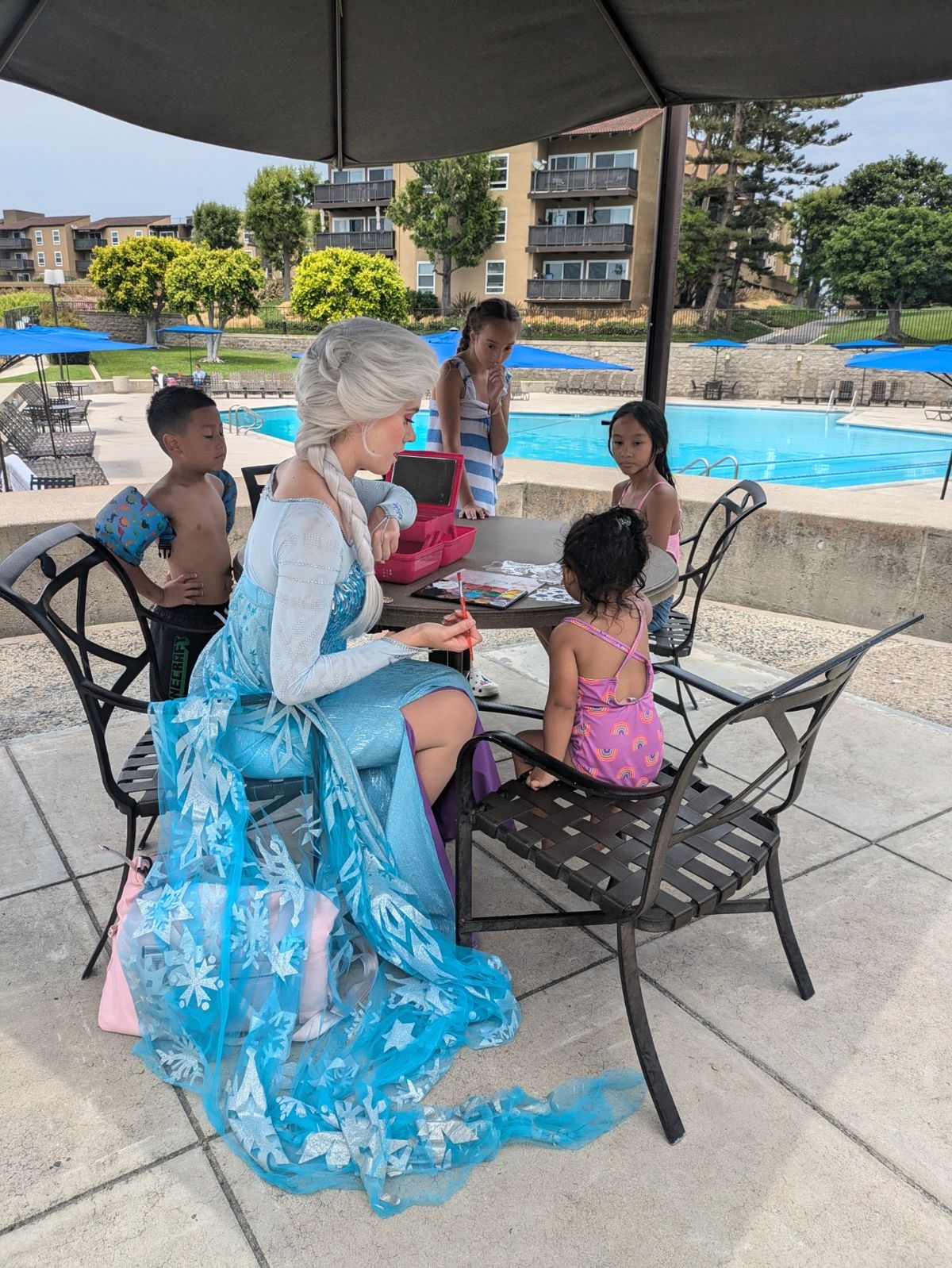 Elsa princess character at a children's birthday party singing with kids